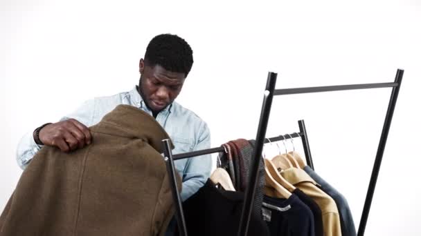Black American Man Choosing Winter Coat Variety Coats Hanging Rack — 图库视频影像
