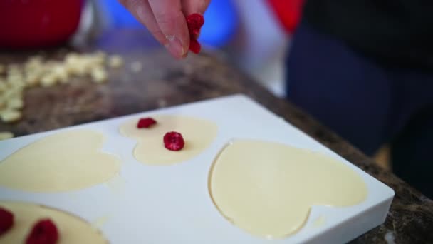 Unrecognisable Chocolatier Placing Freeze Dried Raspberries Heart Shaped Mold Filled — Video Stock