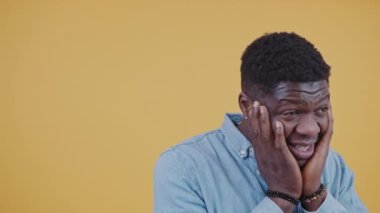 Astonished black American man touching cheeks with palms surprised man isolated. High quality 4k footage