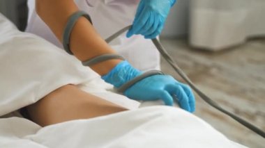 Procedure for removing cellulite on female thigh beauty ultrasonic massage therapy at a salon. High-quality 4k footage