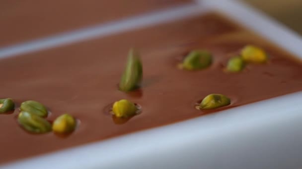 Close Pistachios Sprinkled Melted Chocolate Filled Mold Chocolate Production Process — 图库视频影像