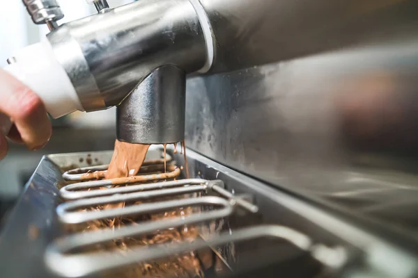 stock image Tasty chocolate ice cream making with batch freezer machine. Unrecognizable person using ice cream machine. High quality photo