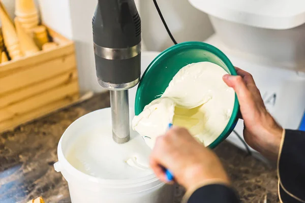 stock image Close shot of man hands mixing ice cream ingredients with a blender. High quality photo