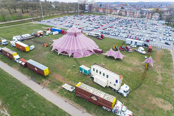 wide view of a big circus tent and parking lot behind it, UK. High quality photo