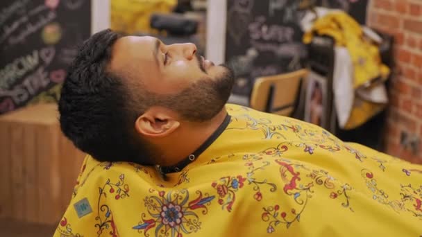 Smiling Indian Man Resting His Head Chair Barbershop Getting His — Stock Video