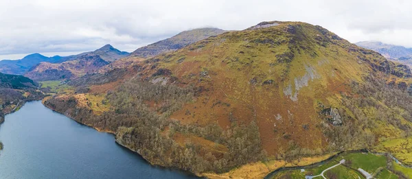 stock image Track in Snowdonia National Park, North Wales, United Kingdom. Aerial birds eye perspective of mountain range landscape and lakes. High quality photo