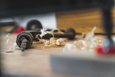 Geleneksel araç gereç. Elle yapılan matkap, atölye masasında ahşap kaplamaların yanında duruyor. Carpenter stüdyo konsepti. Yüksek kalite fotoğraf