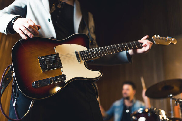 Young musicians practising the song in rehearsal room. High quality photo