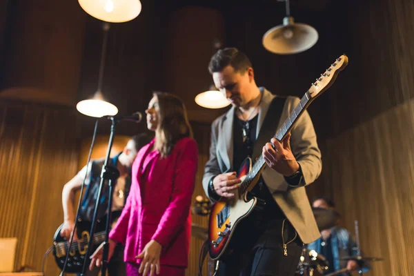 stock image Young musicians practising the song in rehearsal room. High quality photo