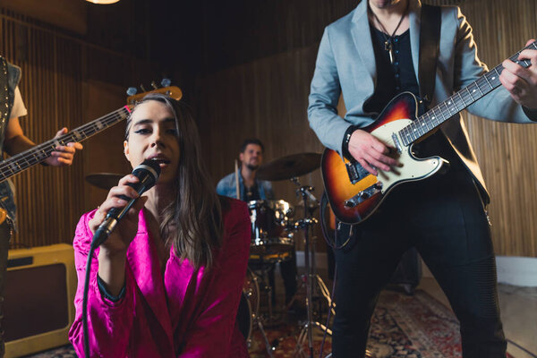 Young indie rock band playing the rehearsal before the concert . High quality photo