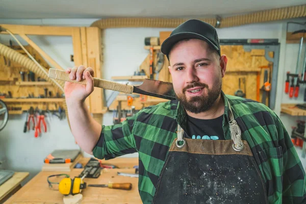 stock image Portrait of a carpenter posing with a Japanese saw traditional woodworking tools. High quality photo