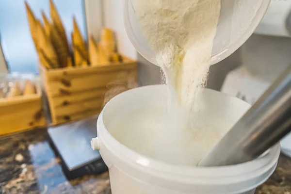 stock image Chef adds sugar in a blender for preparing ice cream top view of kitchen counter. High quality photo