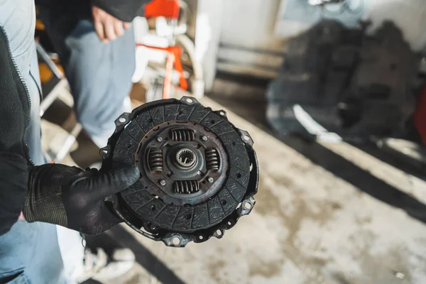 机械手牵着一个破离合器在汽车修理店 高质量的照片 — 图库照片
