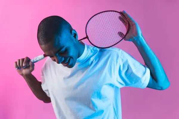 Leende Svart Man Håller Badminton Racket Isolerad Mot Rosa Bakgrund — Stockfoto