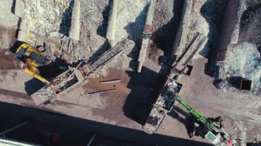 Excavators loading plastic onto conveyor for shredding it at waste recycling plant in Netherlands. High quality 4k footage