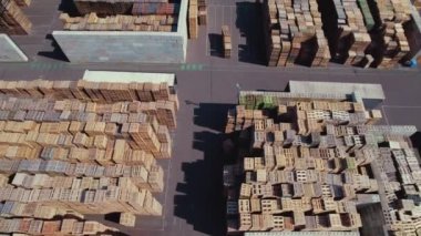 Birds eye view video of dozens of pallets stacked together. High quality 4k footage