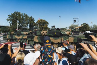 16.08.2023 Varşova, Polonya. Açık hava askeri olay konsepti. Askerli tanklar tören sırasında şehirden geçiyorlar. Ön planda fotoğraf çeken heyecanlı insanlar. Yüksek kalite fotoğraf