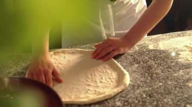 Pizza için hamuru gererken yakın plan çekimler, masada domates sosu. Yüksek kalite 4k görüntü
