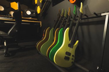 colorful electric guitars leaning on a wall in the studio. High quality photo clipart