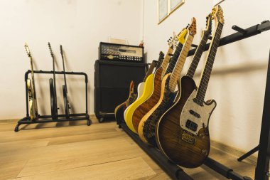 Müzik stüdyosunda farklı renk gitarlar, amplifikatörler ve hoparlörler var. Yüksek kalite fotoğraf