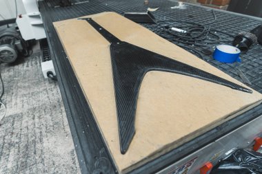 carbon fiber guitar in the MDF board mold, at the factory, guitar making concept. High quality photo