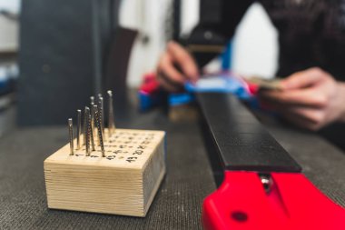 man placing frets on a guitar, guitar making concept, numbered frets in the wooden piece. High quality photo