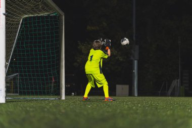Bir kalecinin topu elle tutması, kızların futbol oynaması, aktif gençler. Yüksek kalite fotoğraf