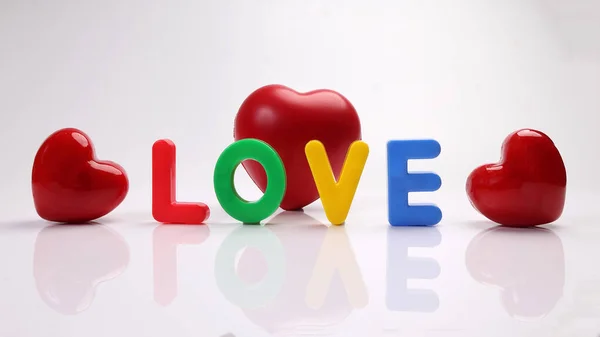 stock image red green blue yellow plastic toy capital font letter alphabet love on white background red hart love shape copy text space concept