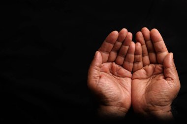 Asian dark skin top view holding five finger palm of hand  praying begging asking giving on black background 