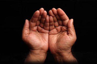 Asian dark skin top view holding five finger palm of hand  praying begging asking giving on black background 