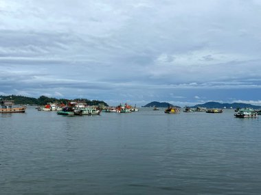 ships boats fishing trollers on ocean sea water of south China sea bay kota Kinabalu sabah 