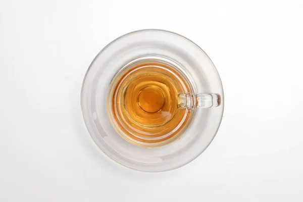 stock image Hot tea in transparent glass cup saucer on white background 