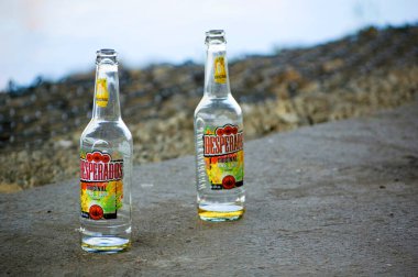 Poznan, Poland, July 3th 2022: Two empty Desperados bottles near the riverside.