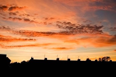 Orange clouds against evening sky.