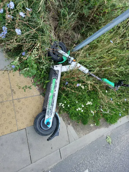 Poznan, Polonya - 4 Ağustos 2023: Kaldırımda duran kırık scooter.