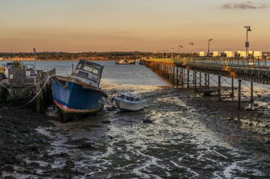 Hythe, Hampshire, England, UK - September 29, 2022: Evening light at Hythe Pier and a ferry departing clipart
