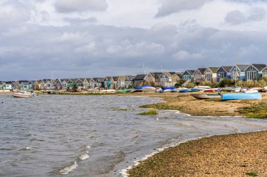 Mudeford Sandbank, Dorset, England, UK - September 27, 2022: View of the beach huts and the boats in Webb's Bay clipart