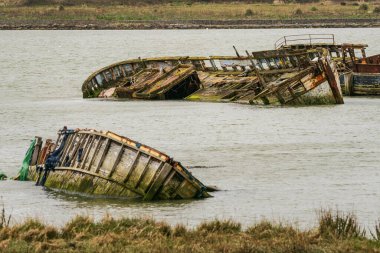 Hoo Marina Park, Kent, England, UK - March 21, 2023: Shipwrecks on the banks of the River Medway clipart