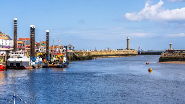 stock image Whitby, North Yorkshire, England, UK - June 21, 2023: View from Whitby Bridge over the River Esk towards the pier