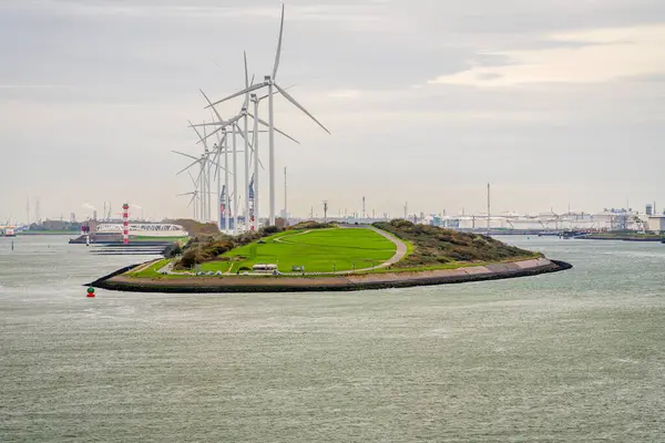 stock image Europort, Port of Rotterdam, South Holland, Netherlands - November 15, 2022: A lighthouse and wind turbines at the exit from the port