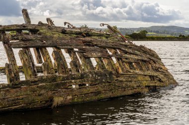 A shipwreck on the banks of the River Clyde in Bowling, West Dunbartonshire, Scotland, UK clipart