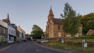 Alston, Cumbria, England, UK - June 14, 2023: Evening with empty streets and the town hall on the right clipart