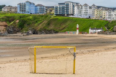 Port Erin, Rushen, Isle of Man - May 18, 2023: Port Erin beach with the beach huts and the lighthouse on the beach clipart