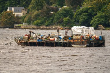 Garelochhead, Argyll and Bute, Scotland, UK - September 20, 2023: A derelict ship full of waste in the Gare Loch clipart