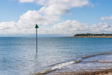 View of the coastline in Christchurch Bay and the houses on Mudeford Sandbank in Mudeford Quay, Dorset, England, UK clipart