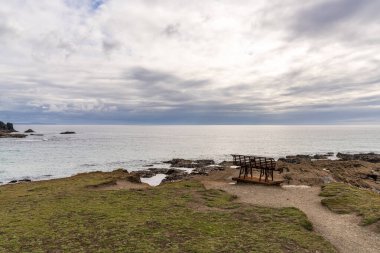 An old rusty bench in Treyarnon Bay, Cornwall, England, UK clipart