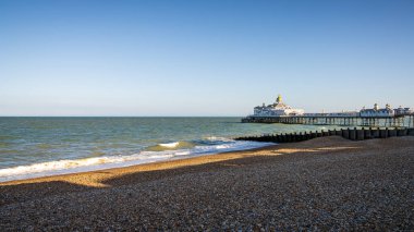 Eastbourne, East Sussex, England - May 08, 2022: Evening mood at the pier and beach clipart