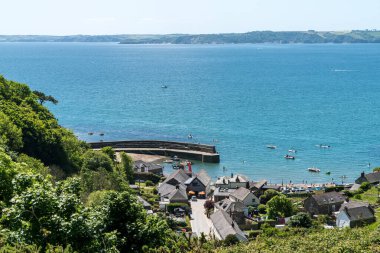 Polkerris, Cornwall, England, UK - May 28, 2022: View of the town and harbour from the top of the cliffs clipart