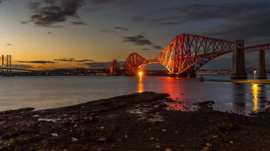 Güney Queensferry, Edinburgh, İskoçya, İngiltere 'den görülen Forth Bridge' de akşam atmosferi