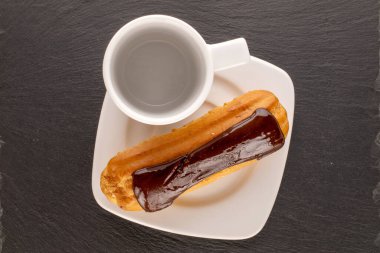 Beyaz tabağı ve beyaz bardağı olan tatlı bir ekkin kayrak taşı, makro, üst görünüm.